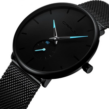Montre homme noire avec cadran minimaliste et bracelet maille en acier noir, aiguilles bleues. - Kiorr™