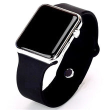 Close-up of black sport smartwatch with silver frame and silicone band on white background.