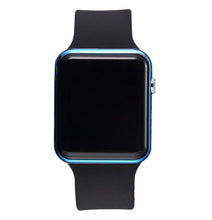 Close-up of black sport electronic watch with black silicone strap and blue metallic bezel on white background.