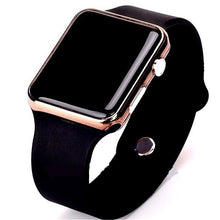 Close-up of black sport electronic watch with rose gold frame and black silicone strap on white background.