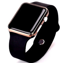 Close-up of black sport smartwatch with rose gold bezel and black silicone strap on white background.